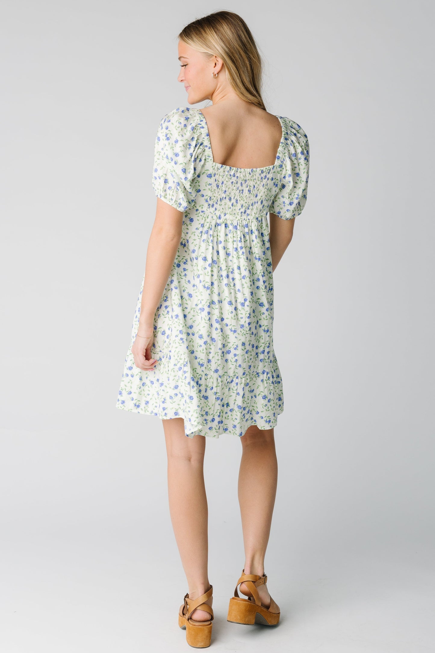 Back view of floral dress with square back neckline and back smocked panel