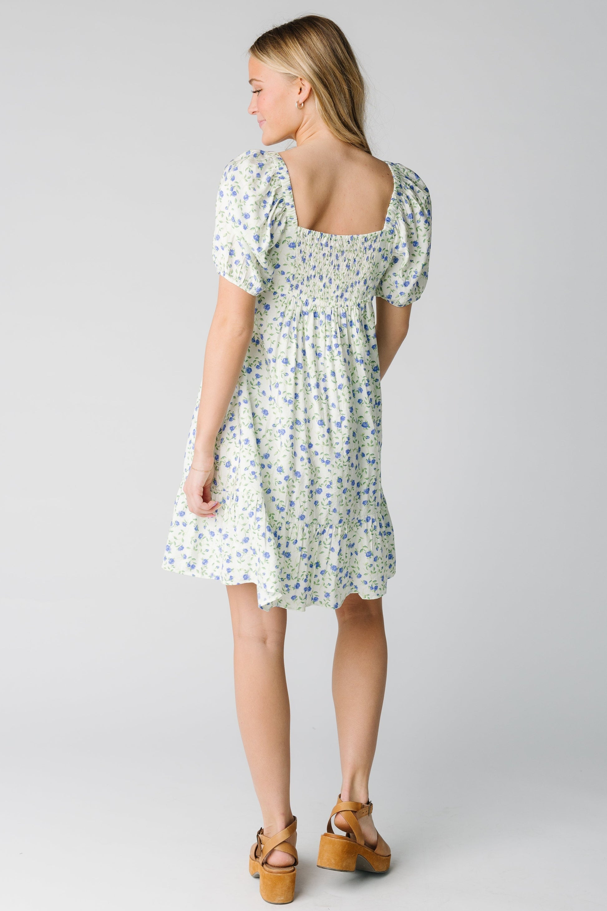 Back view of floral dress with square back neckline and back smocked panel