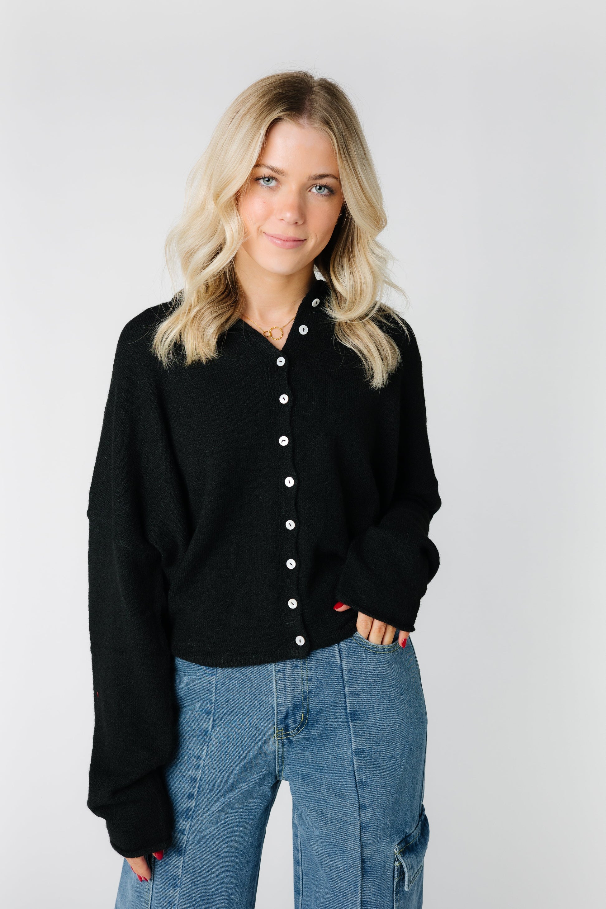 Black cardigan with rolled neckline and hems