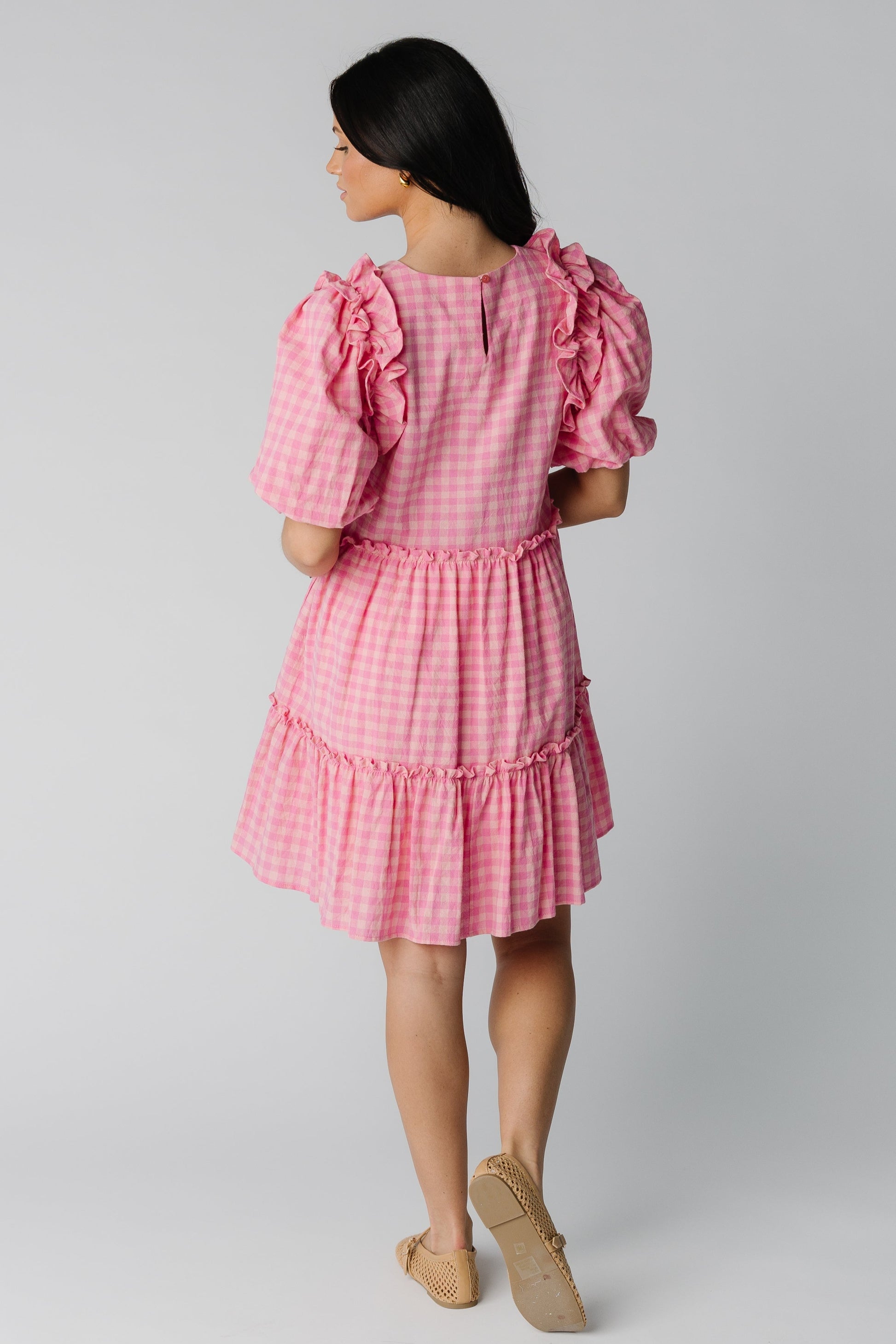 Back view of loose fitting pink gingham dress