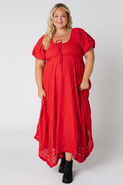 Woman wearing a plus size red maxi with short sleeves