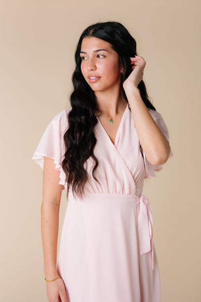 Close view of lt pink wrap maxi with flutter sleeves and V-neckline