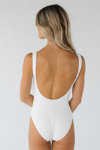 Back view of white one piece with scoop back