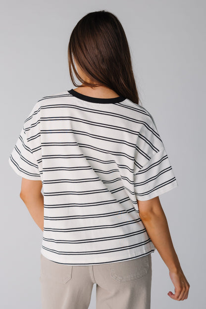 Back view of white and black stripe boxy tee