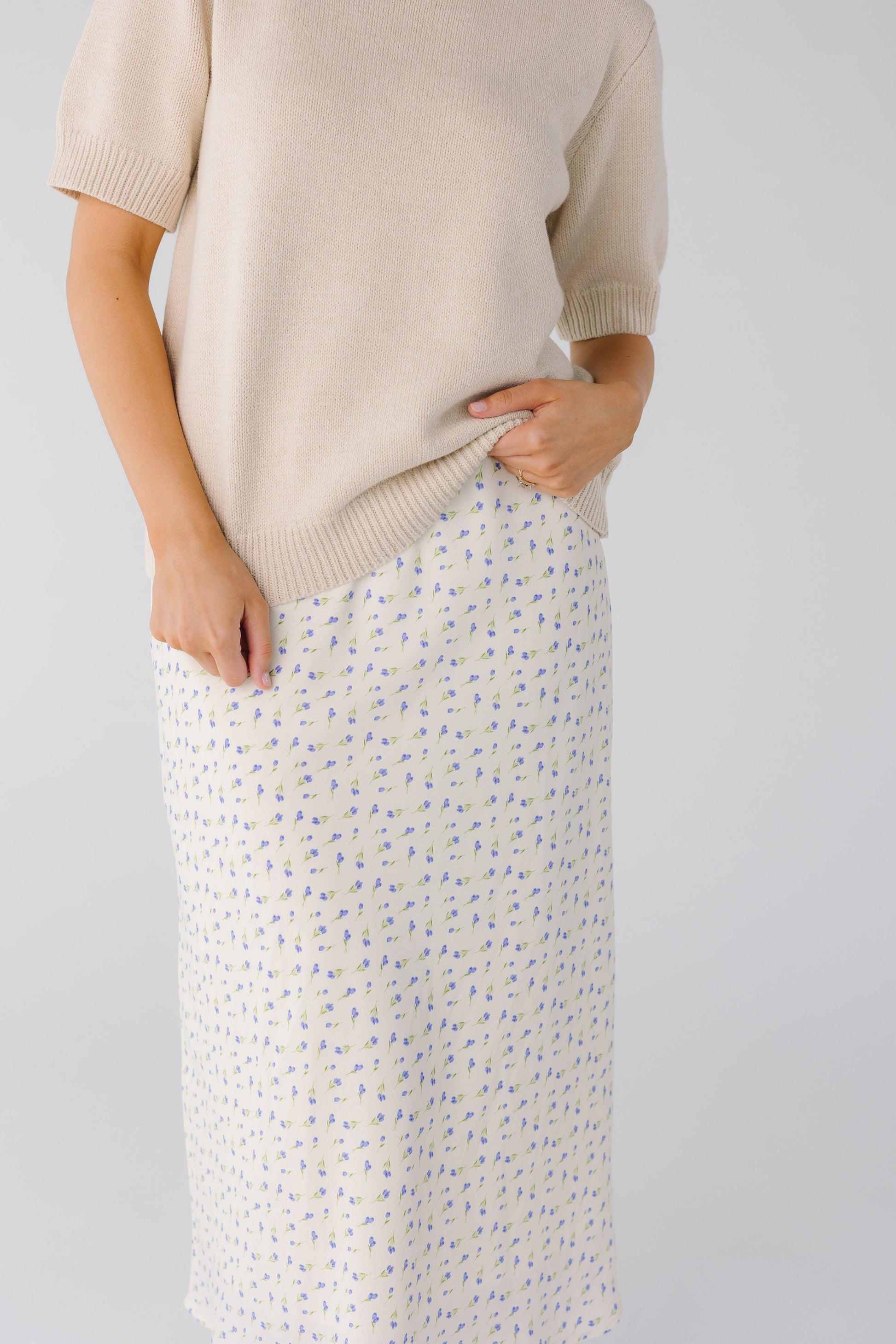 Close view of white and blue floral skirt