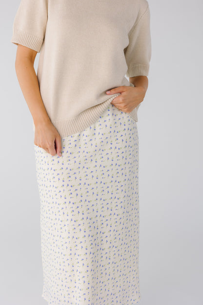 Close view of white and blue floral skirt