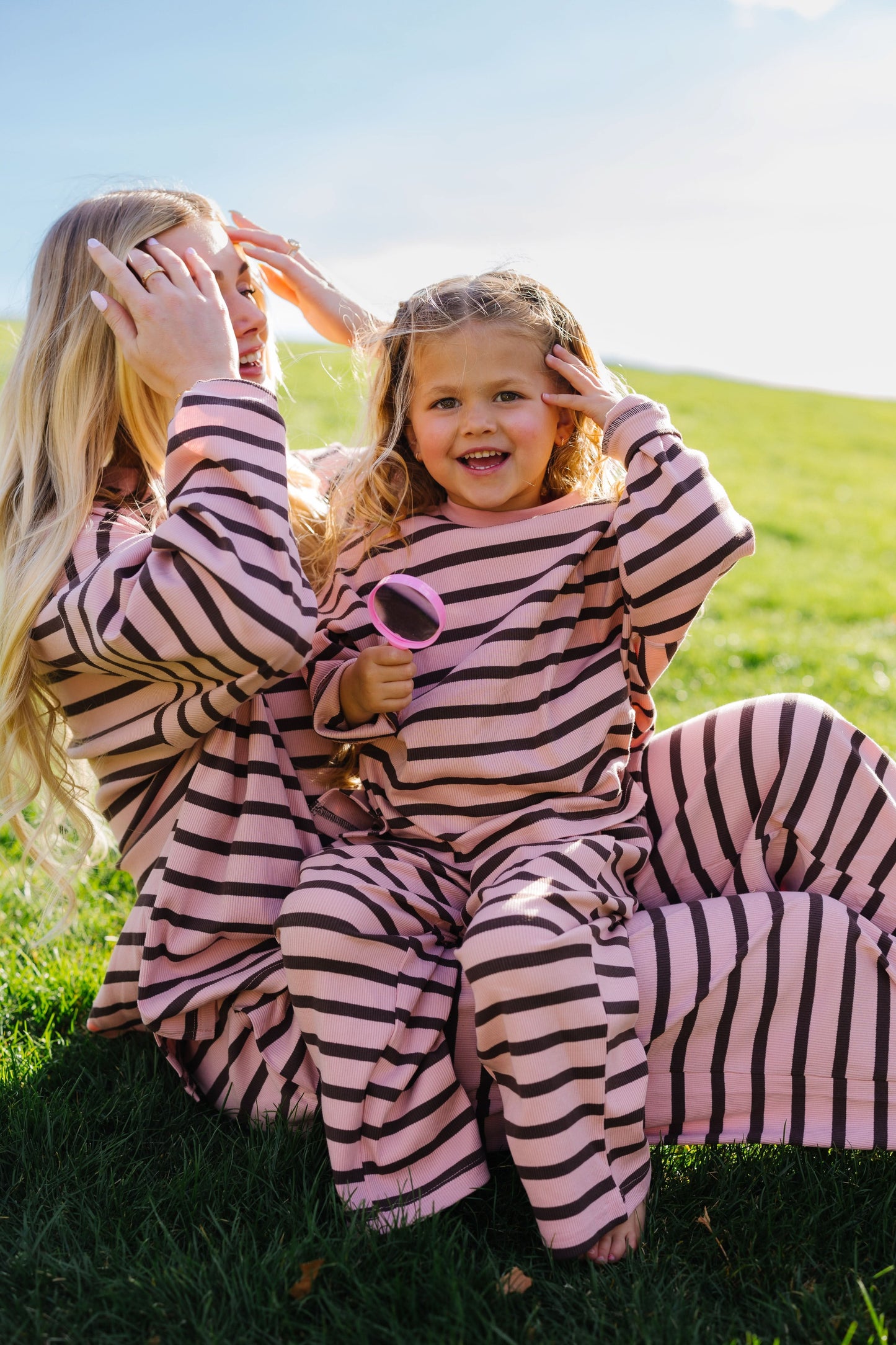 Little girl and adult woman wearing matching pink & brown stripe lounge sets.