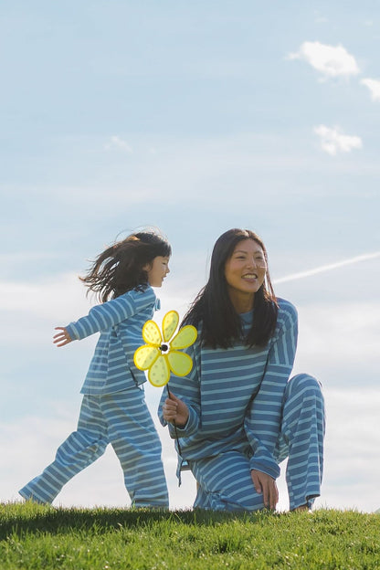 Little girl and woman wearing matching light blue lounge sets with wide cut long leg pants and and long sleeve top.