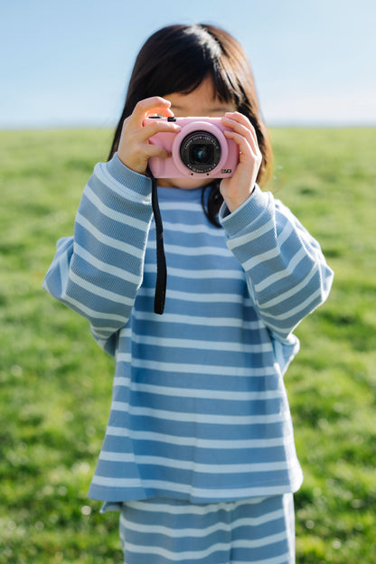 Little girl wearing a modest cotton ribbed, light blue stripe lounge set with a crew neckline ad long sleeves.