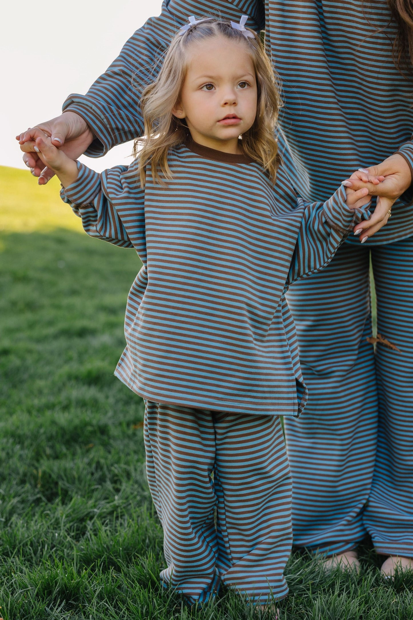 Young girl wearing a loose fitting lounge set in blue & brown stripe for girls size 2-12.