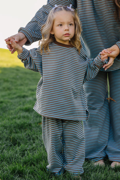 Young girl wearing a loose fitting lounge set in blue & brown stripe for girls size 2-12.