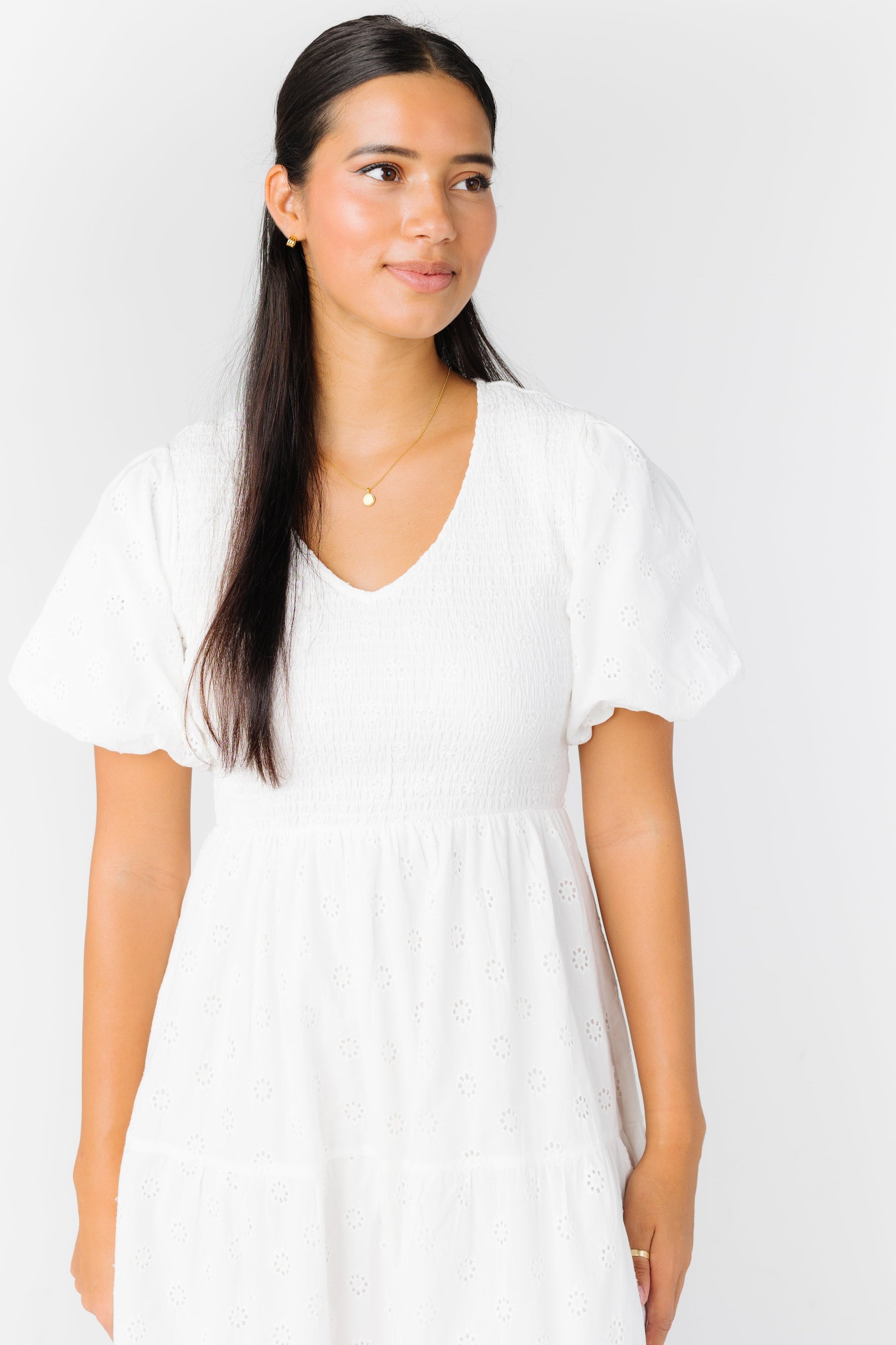 White tiered dress with V-neckline and short sleeves