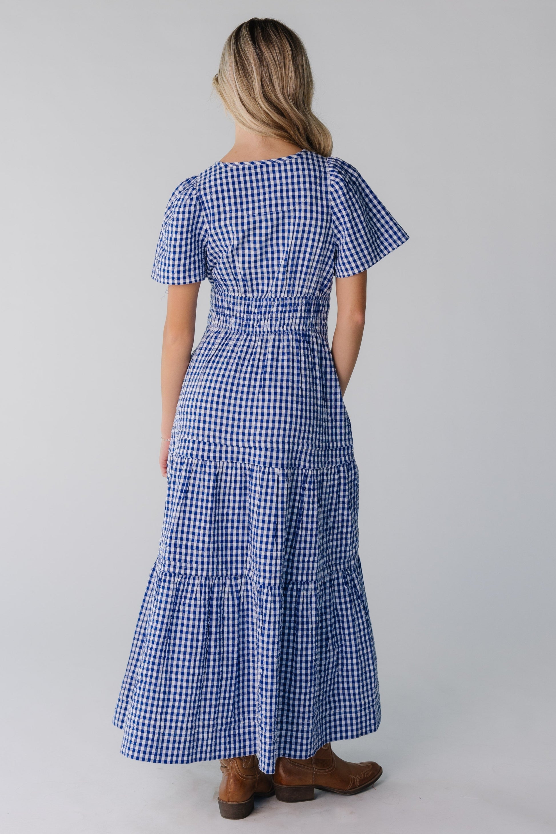 Back view of blue gingham tiered maxi with short sleeves