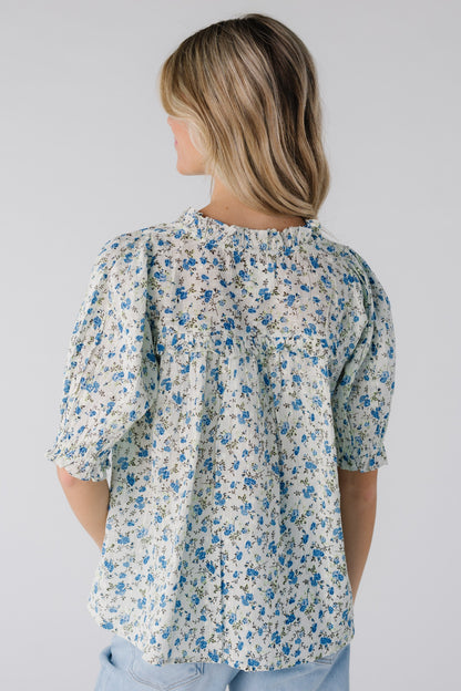 Back view of blue floral short sleeve top