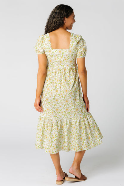 Back view of yellow floral midi dress with square neckline