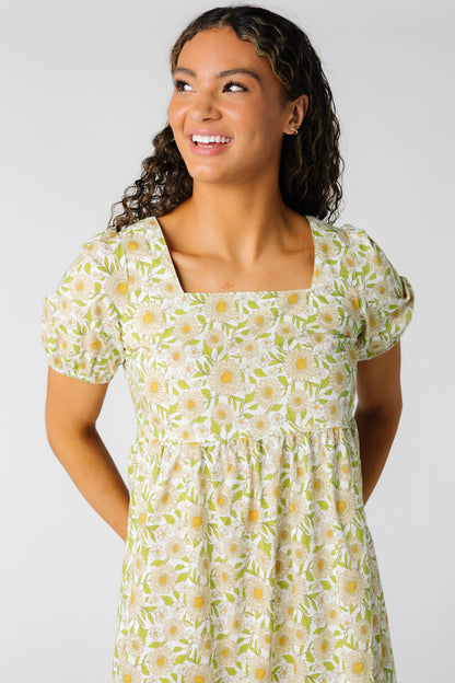 Close view of yellow floral dress with square neckline and short puff sleeves