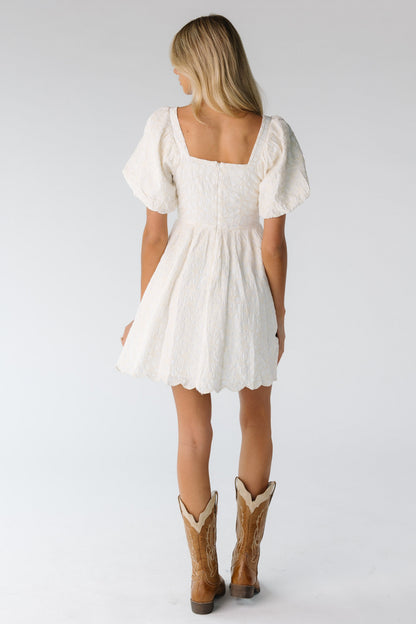 Back view of square neck mini dress in cream with cream embroidery 