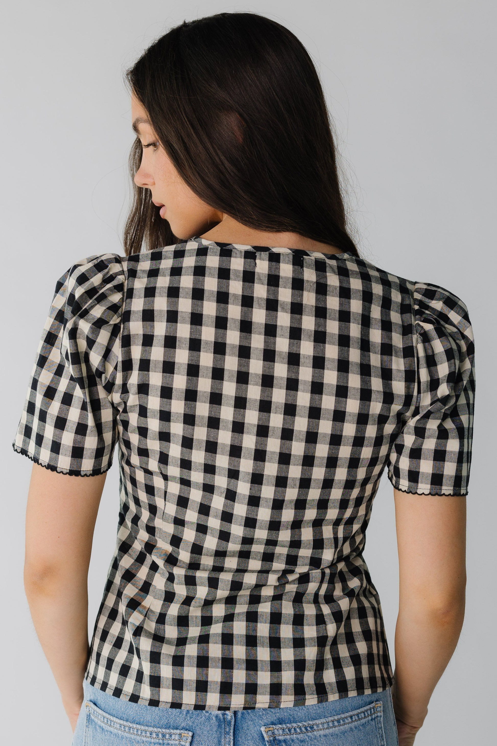 Back view of black and cream short sleeve top