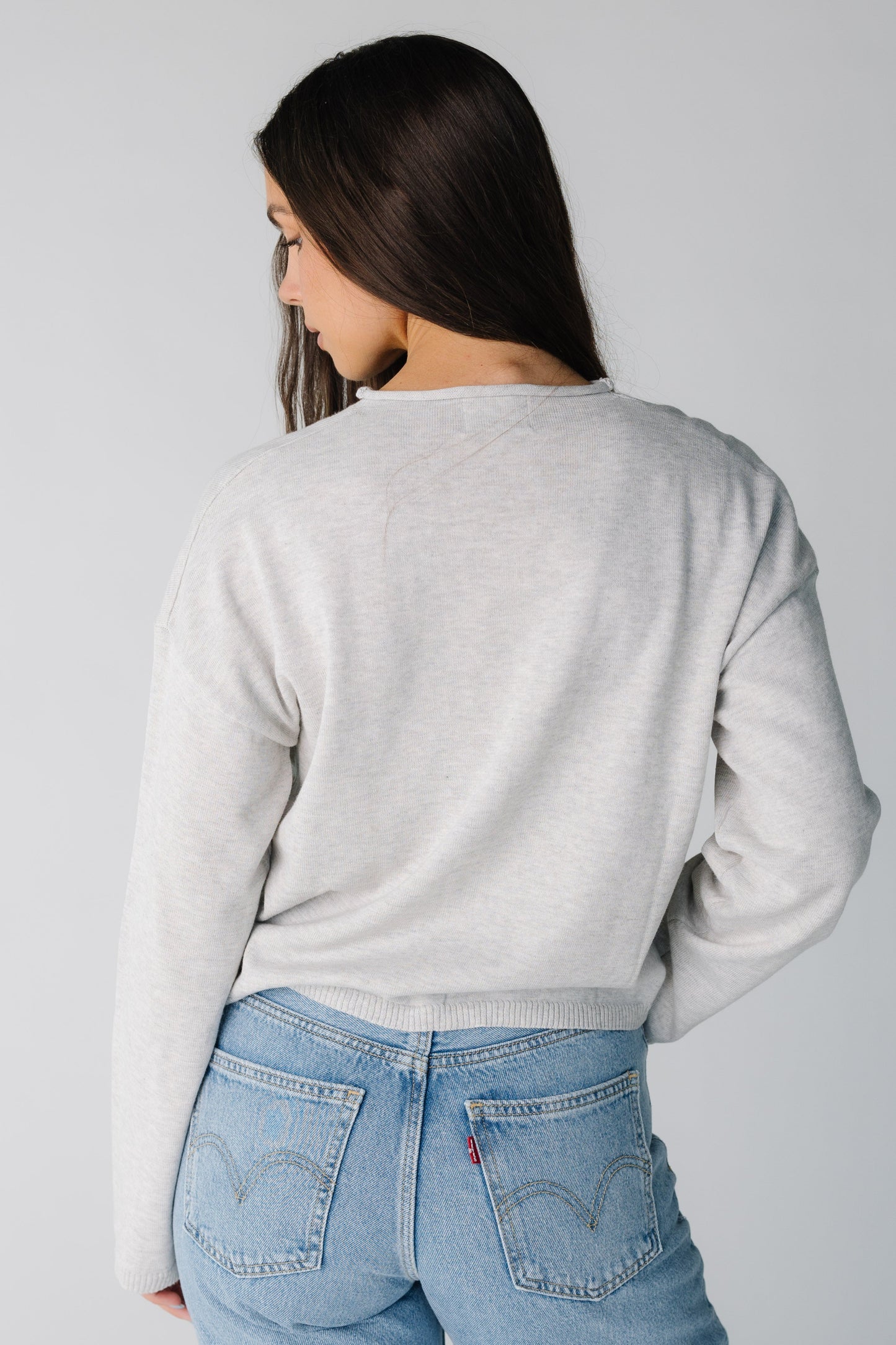 Back view heather grey sweater with long sleeves