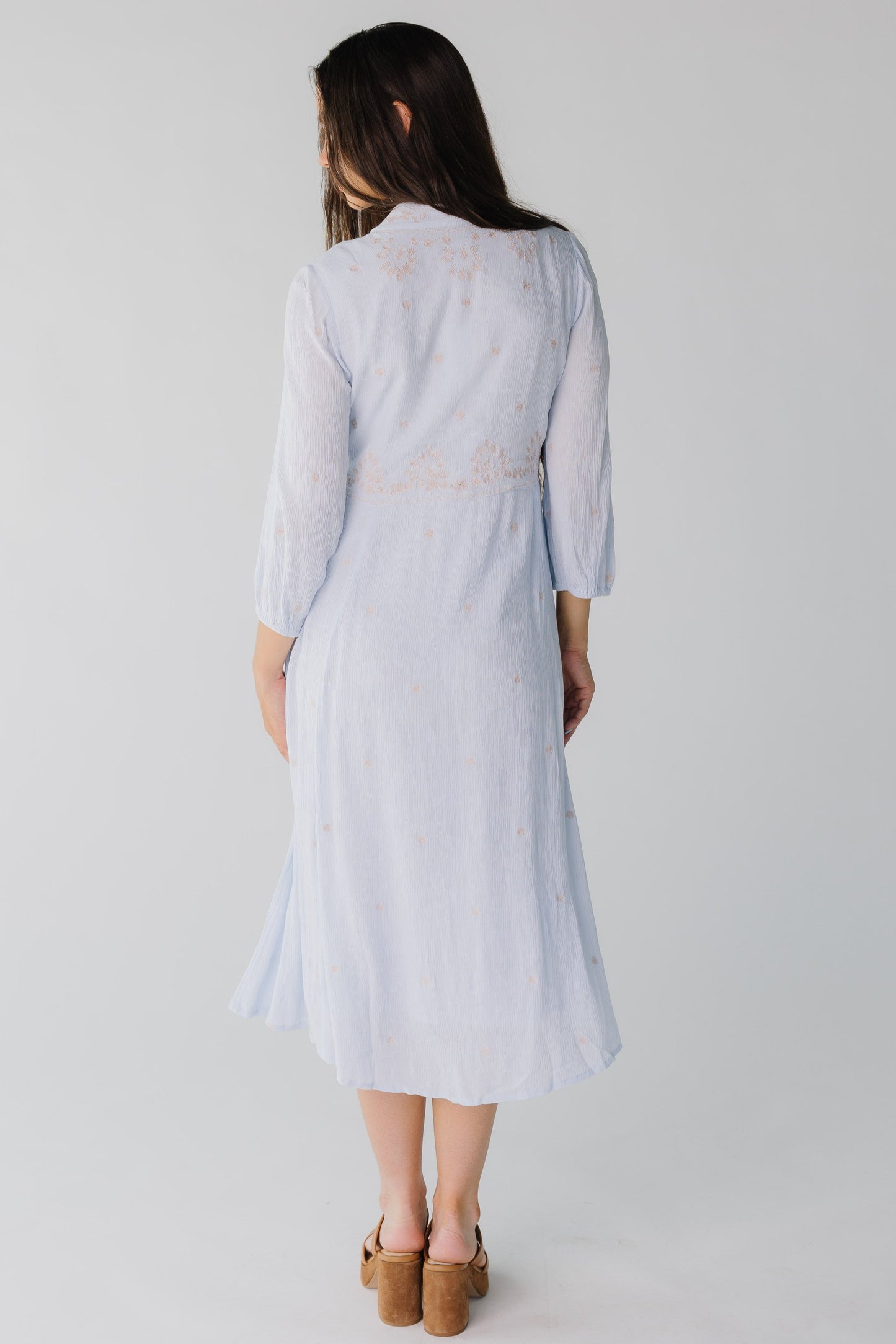 Back view of light blue crepe midi with long sleeves