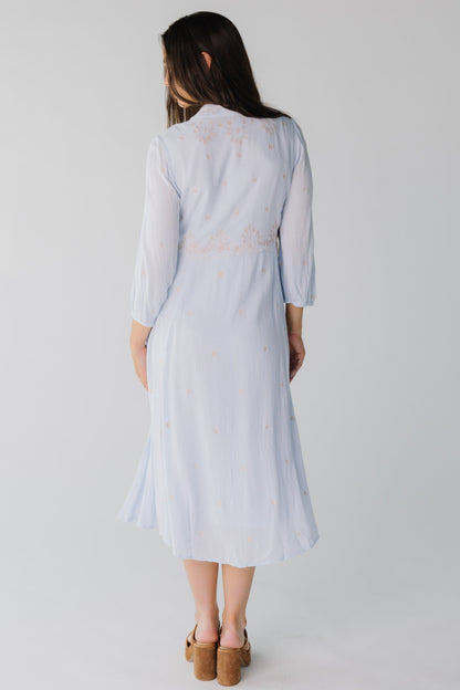 Back view of light blue crepe midi with long sleeves