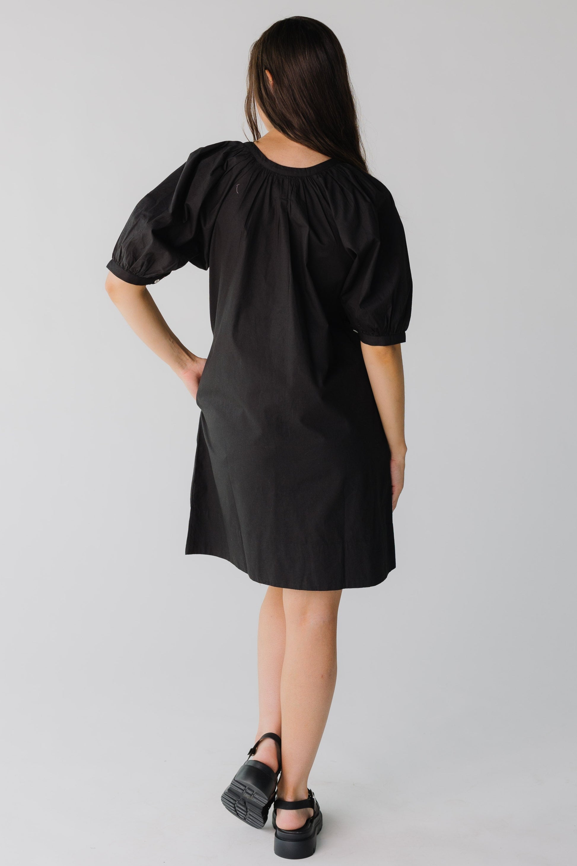 Back view of knee length dress with elbow length sleeves 