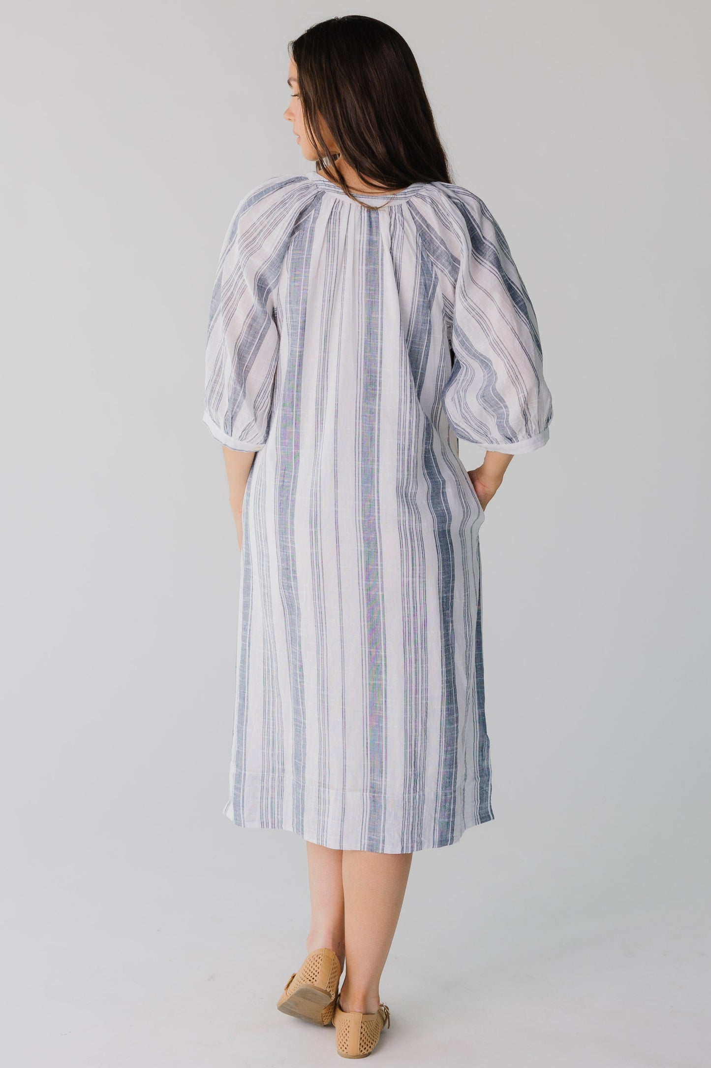 Back view of blue and white stripe midi dress with side pockets