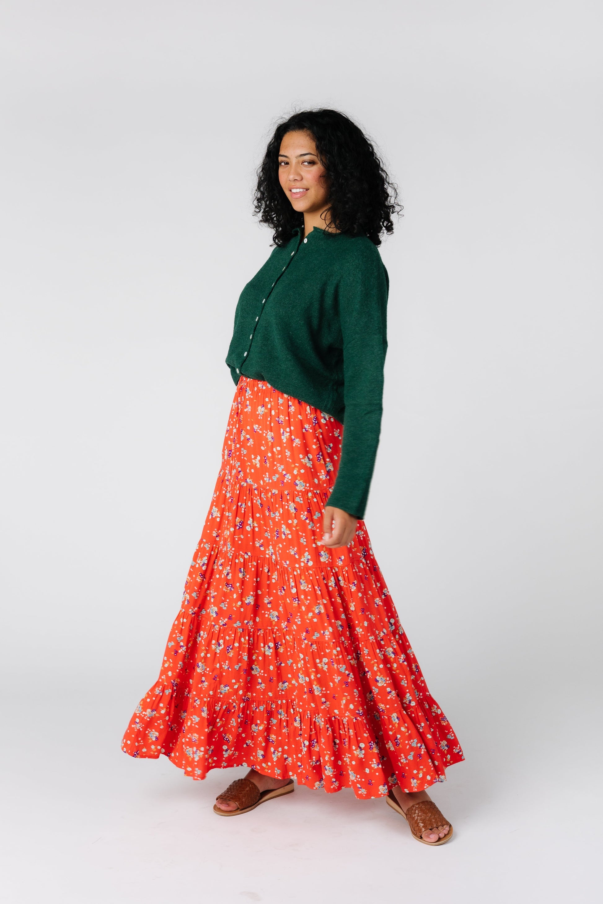 Angled front view of bright coral tiered midi skirt