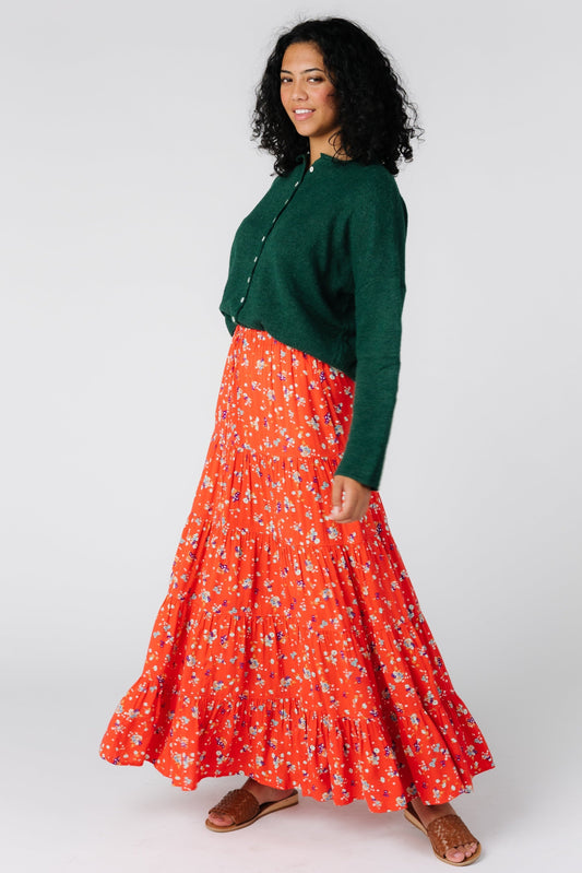 Angled front view of bright coral tiered midi skirt