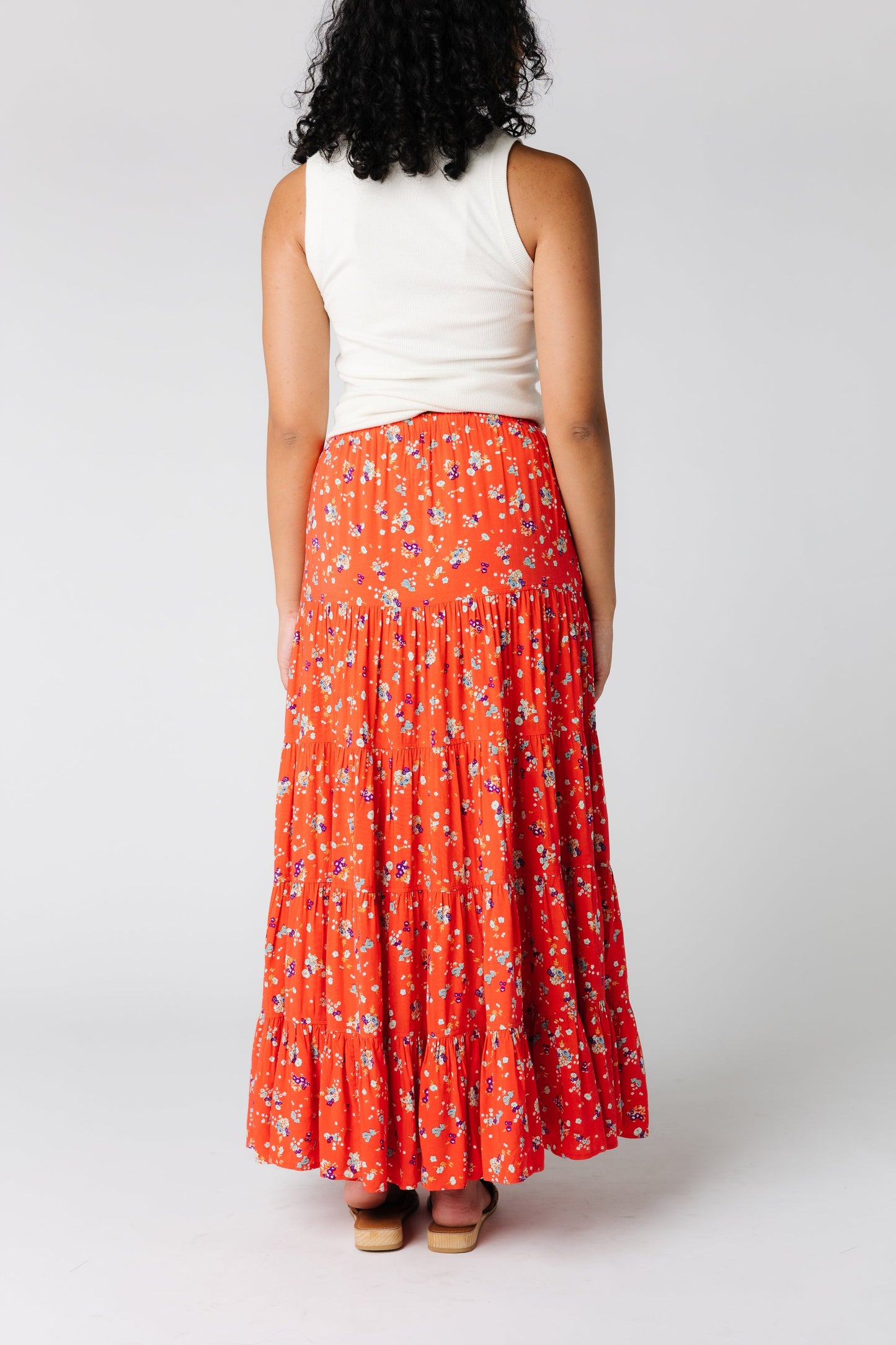 Back view of coral tiered midi skirt