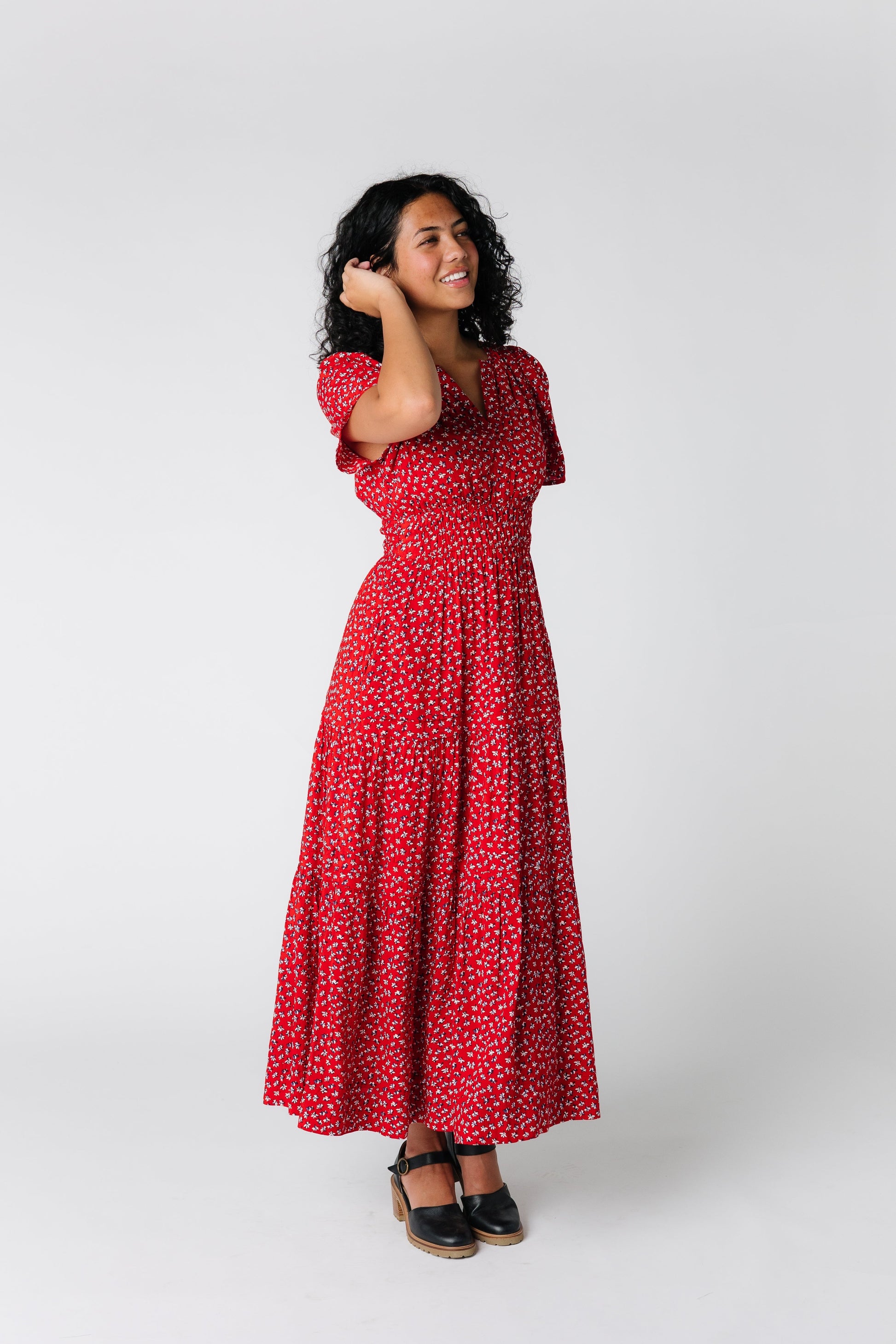 Front angled view of red print midi dress with wide elastic waistband