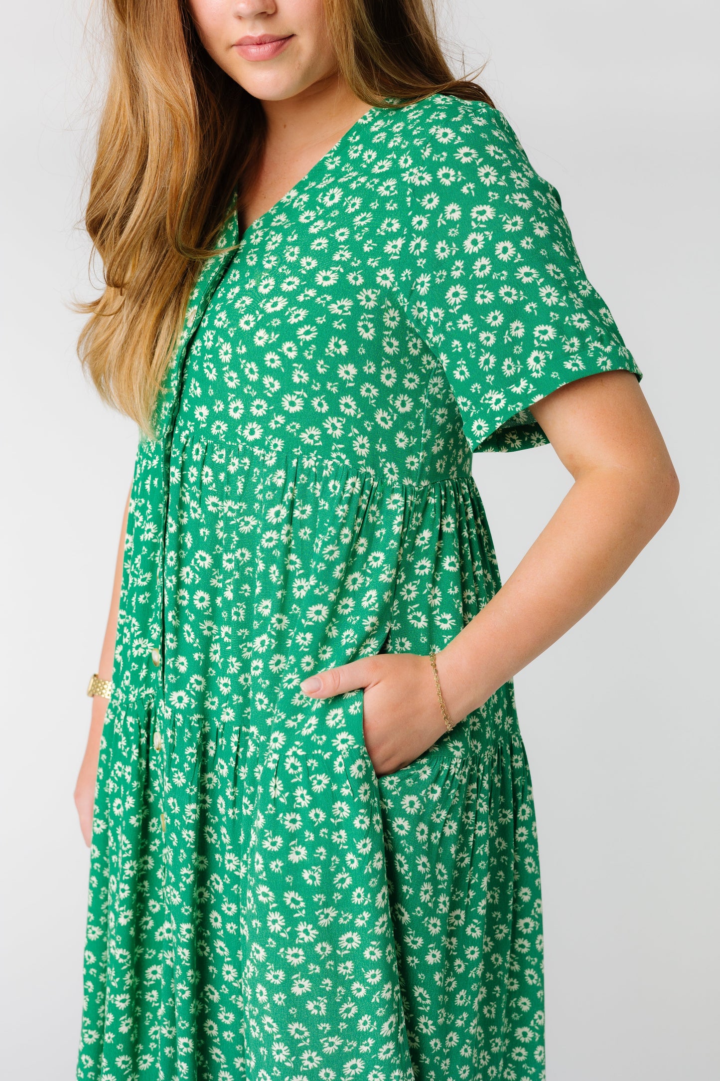 Side view of green floral print dress with side pockets