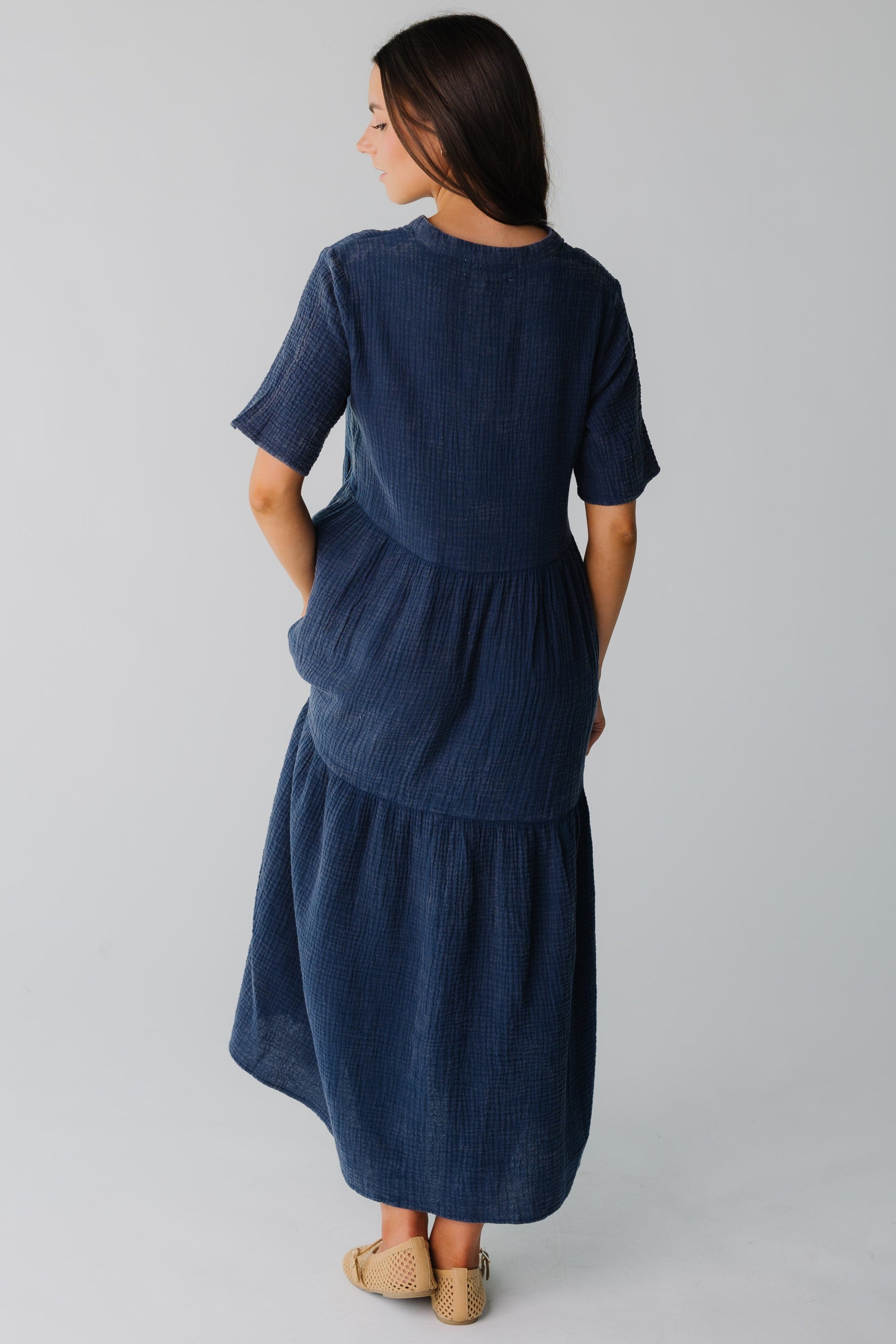 Back view of navy midi dress with wide bottom ruffle and short sleeves