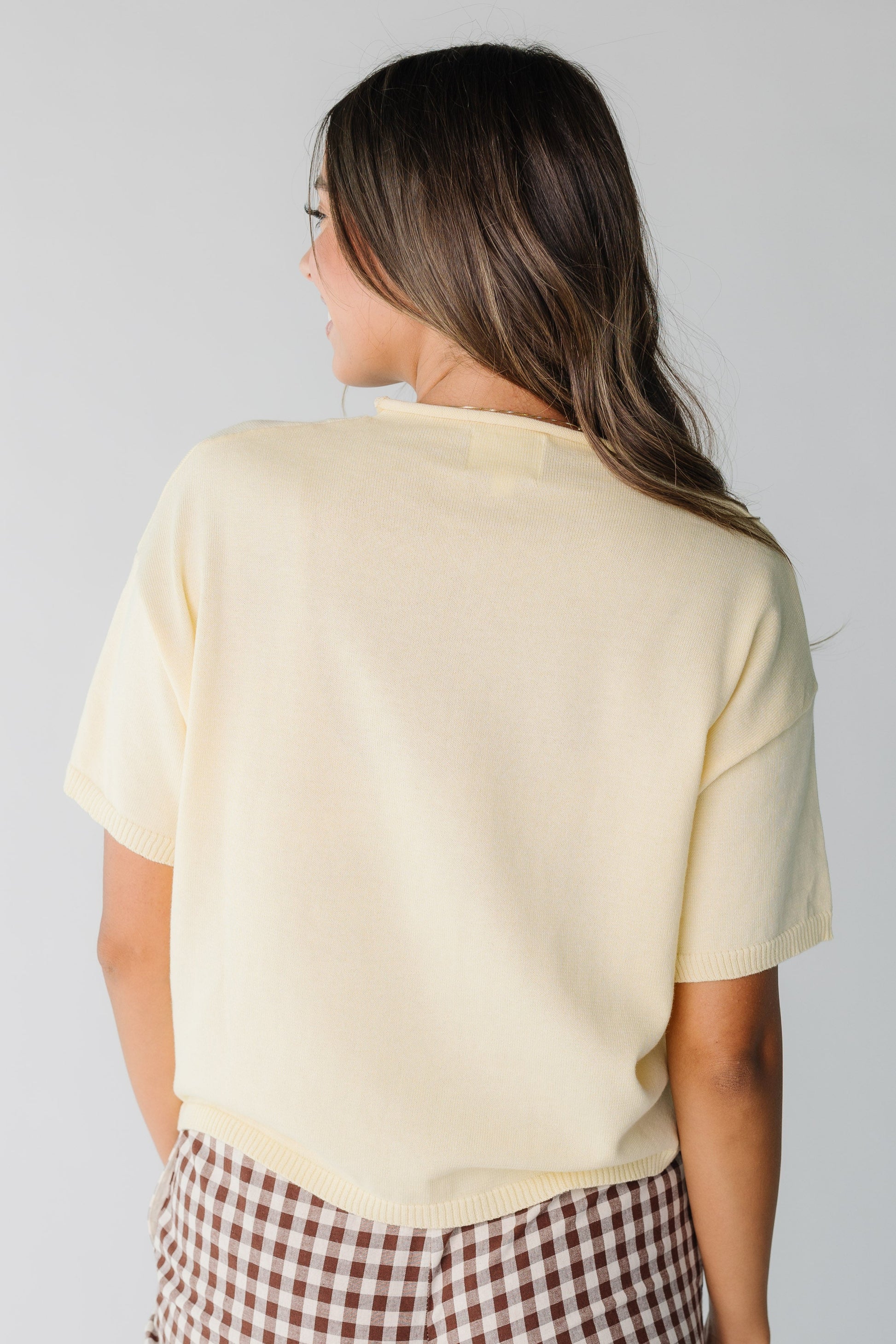 Back view of short sleeve yellow knit top for women