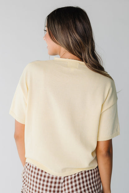 Back view of short sleeve yellow knit top for women