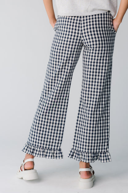 Back view of women's navy gingham wide pant with ruffle