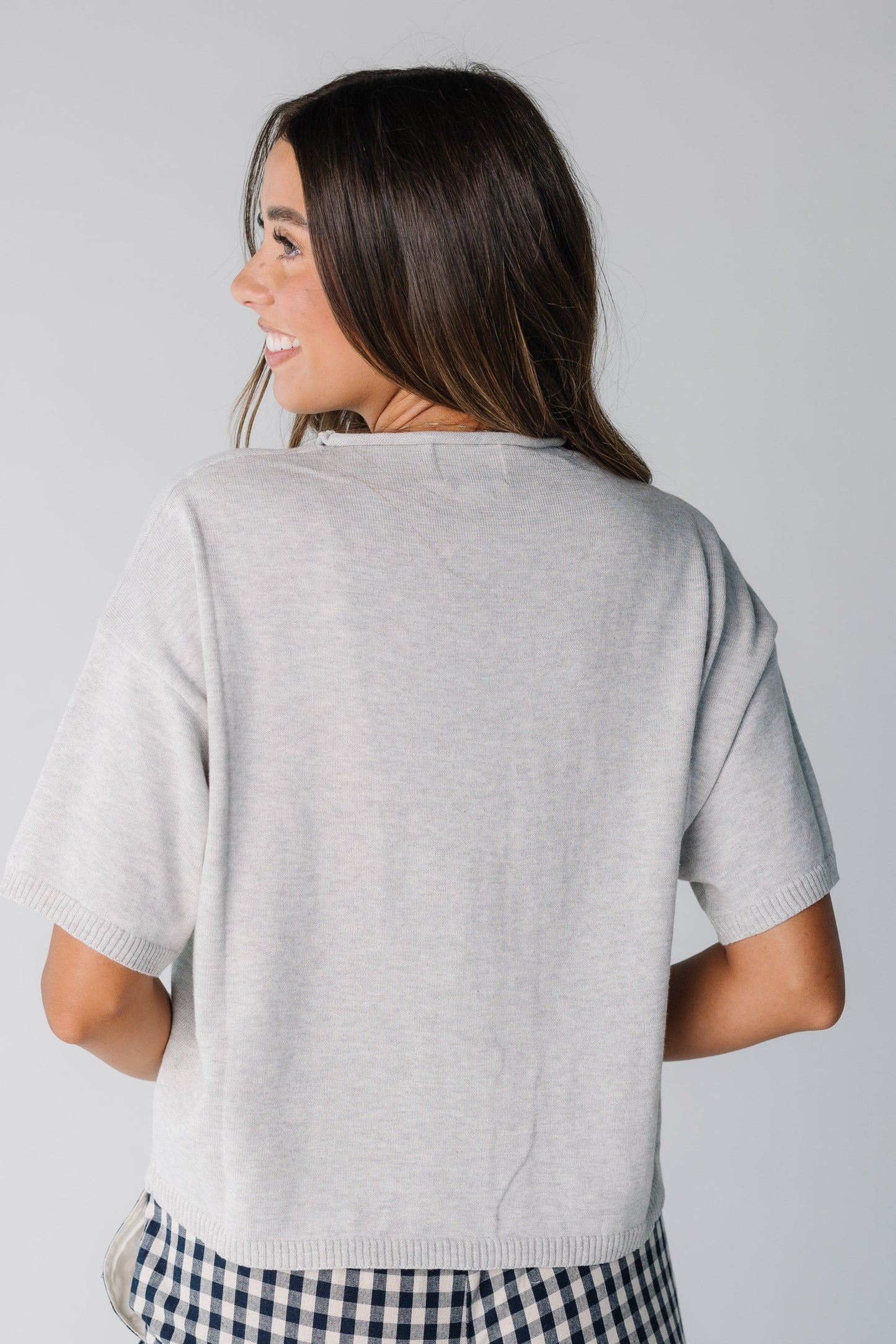 Back view of women short sleeve knit top in heather grey