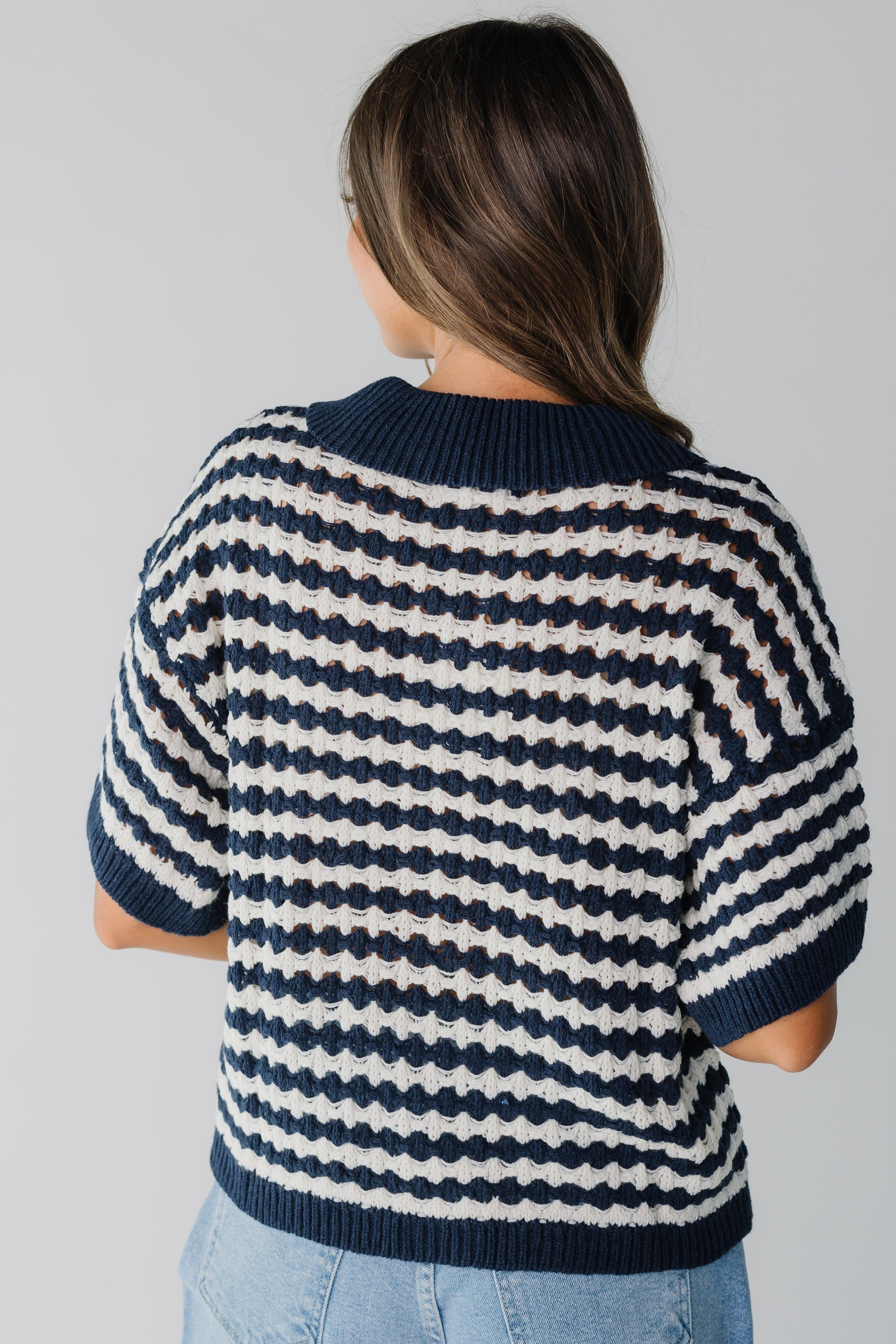 Back view of navy and white stripe cardigan with short sleeves