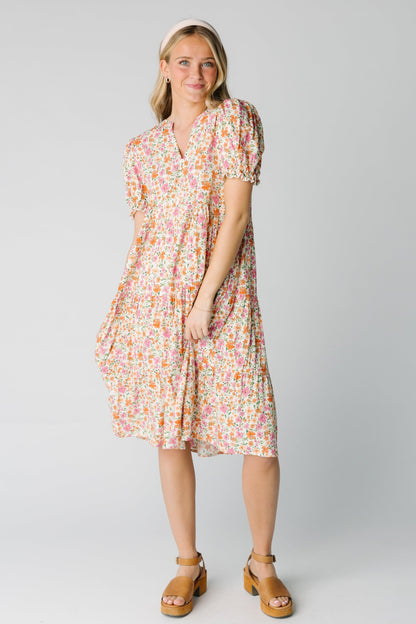 Modest women's pink floral dress with V-neckline and short sleeves