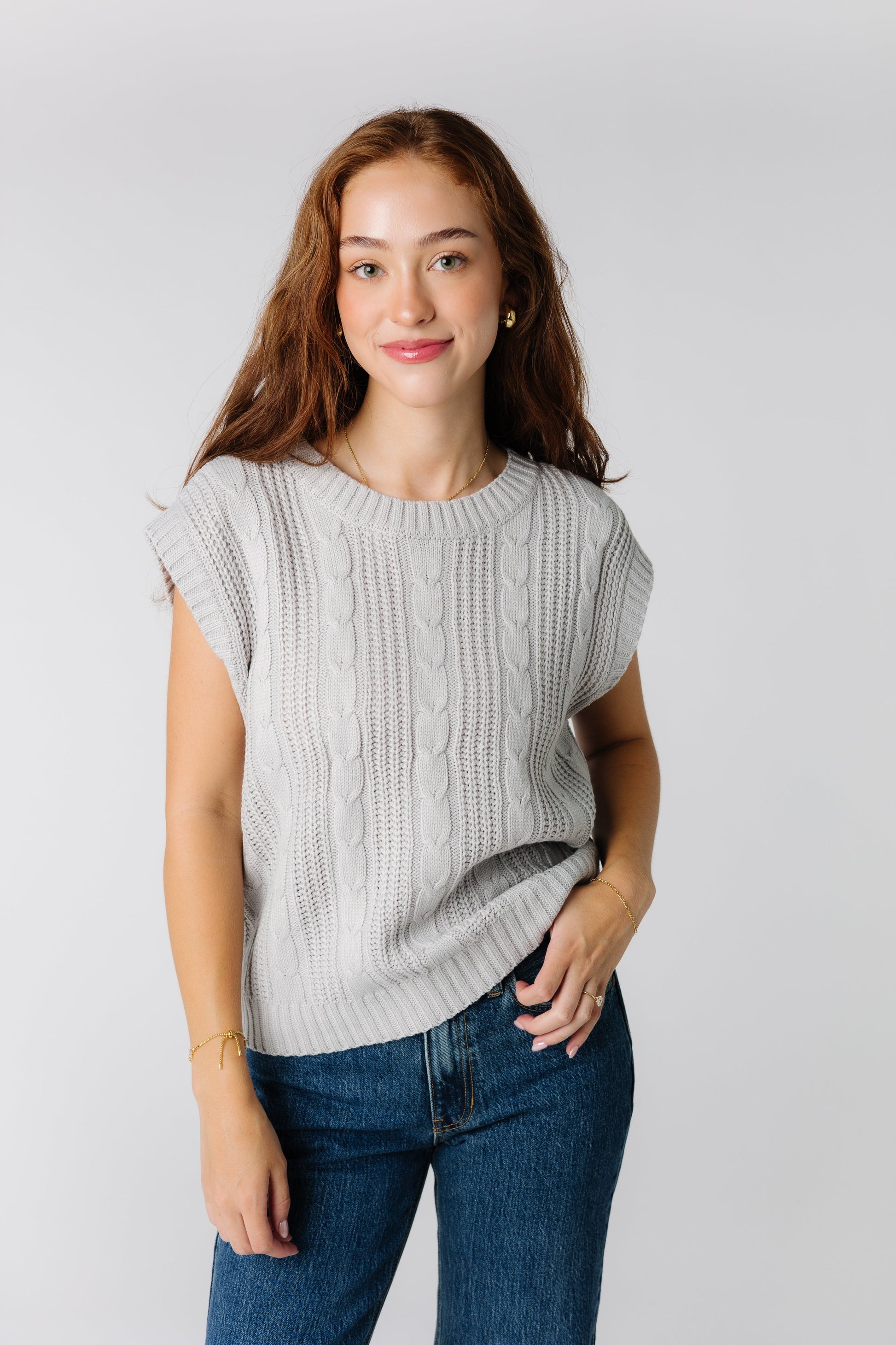 Soft grey sweater vest with vertical cable details