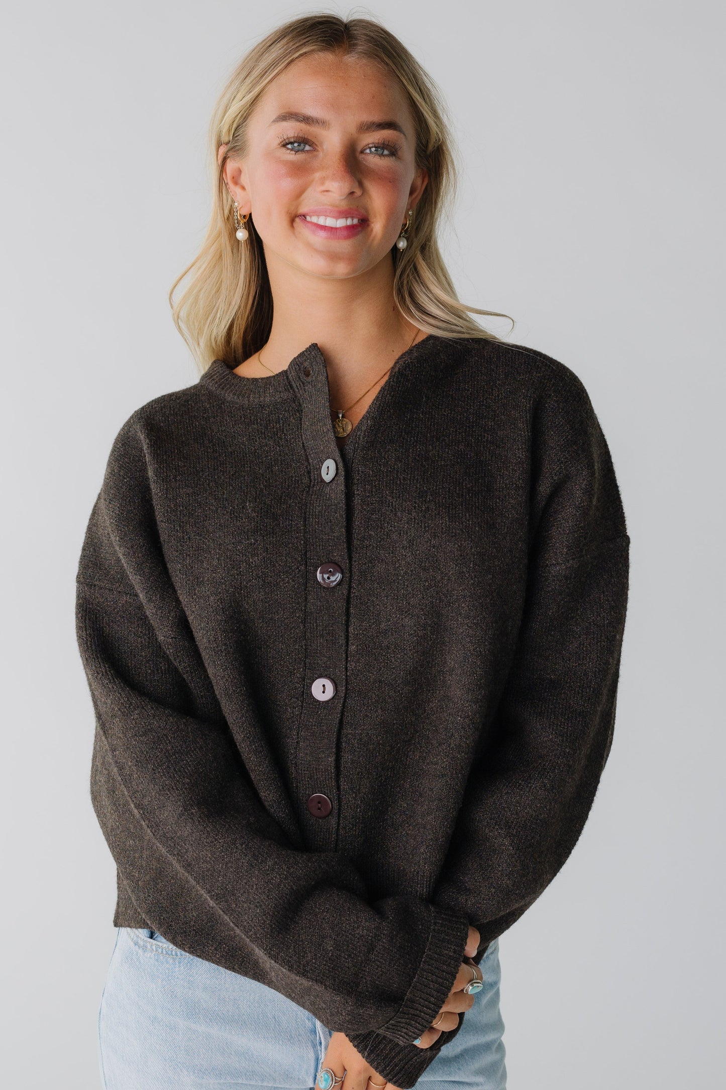 A modest women's button cardigan with long sleeves and crew neckline in brown
