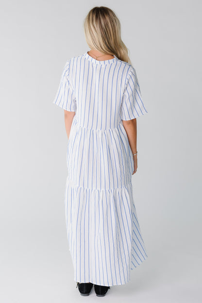 Back view of woman wearing shite and blue midi with short sleeves