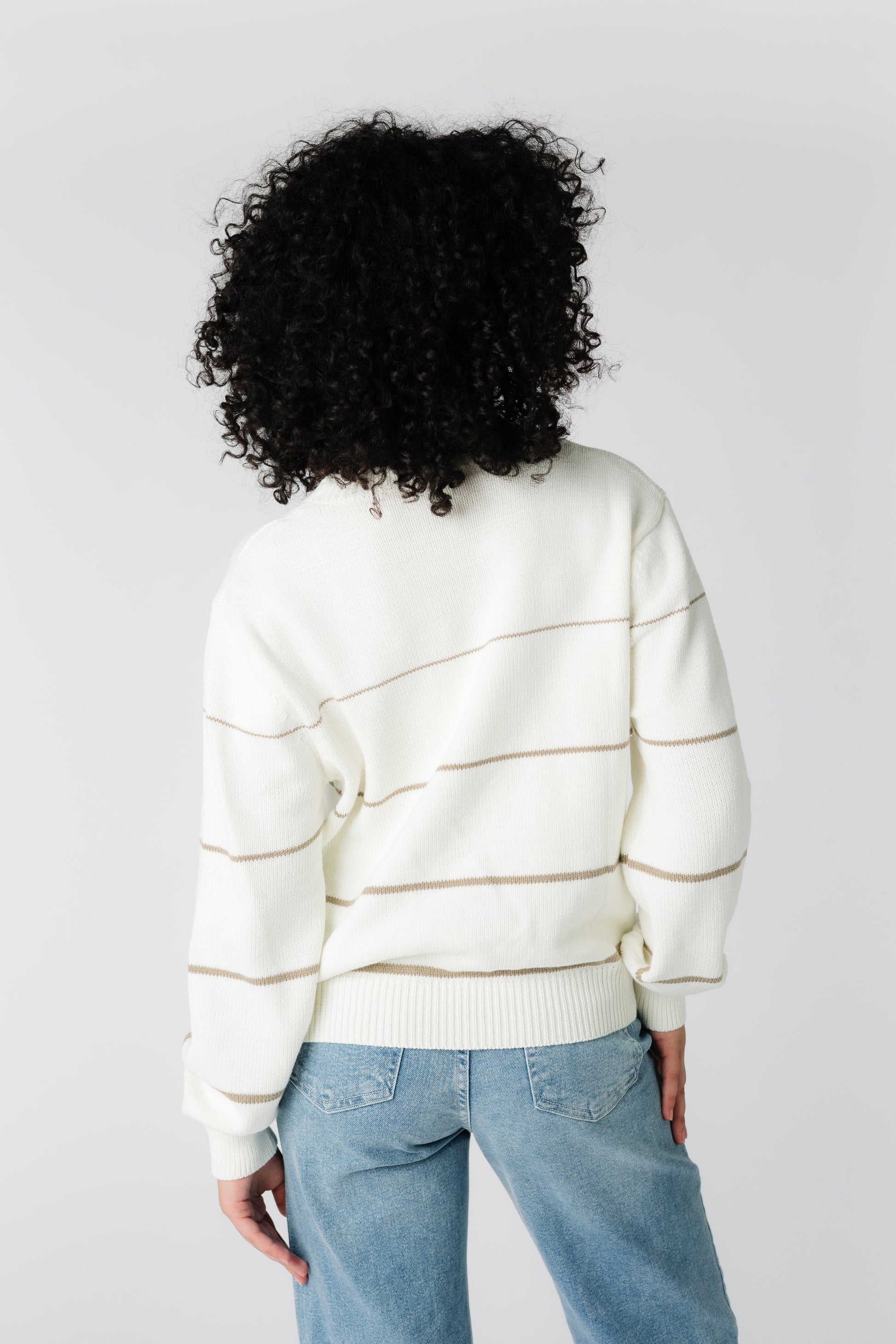 Back view of cream sweater with narrow mocha stripes