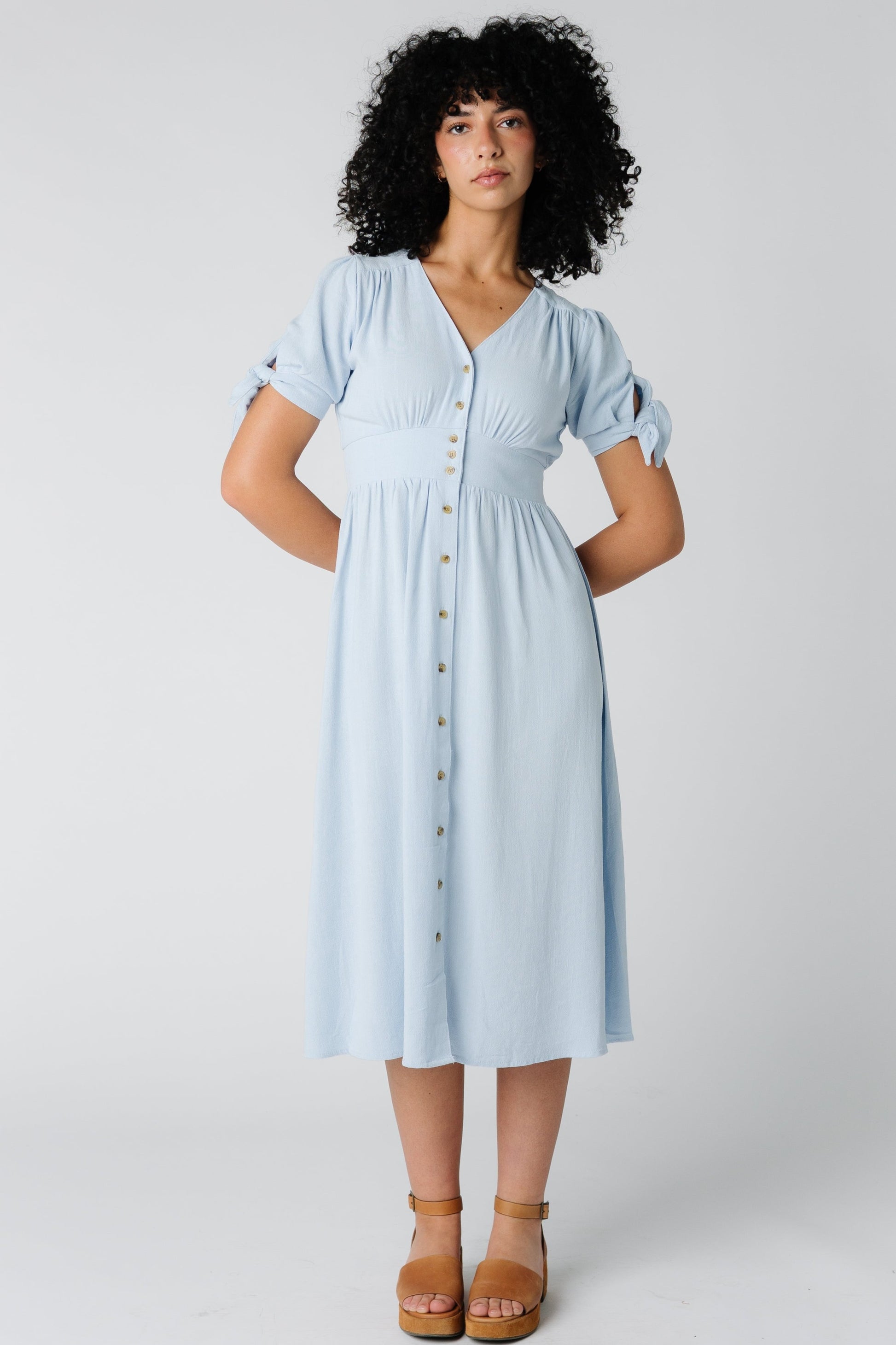 Light blue woven midi with V-neckline and button down dress