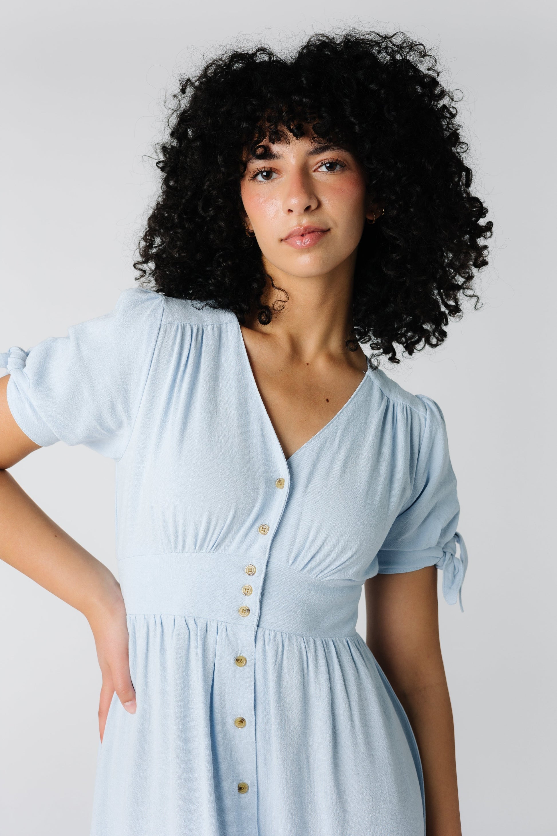 Close view of V-neck dress with snug waistband and short sleeves