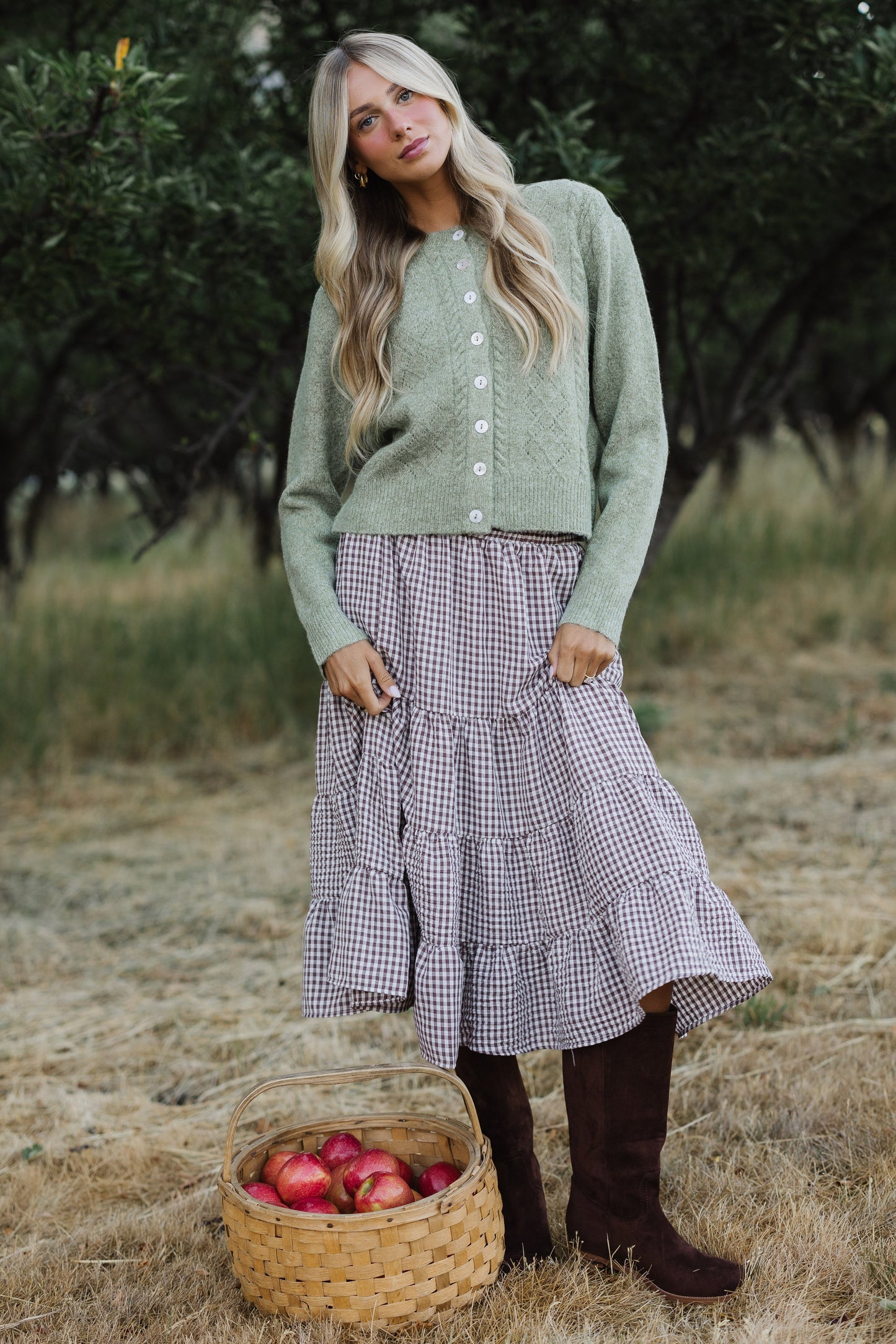 Young woman wearing a brown & white gingham tiered midi skirt.