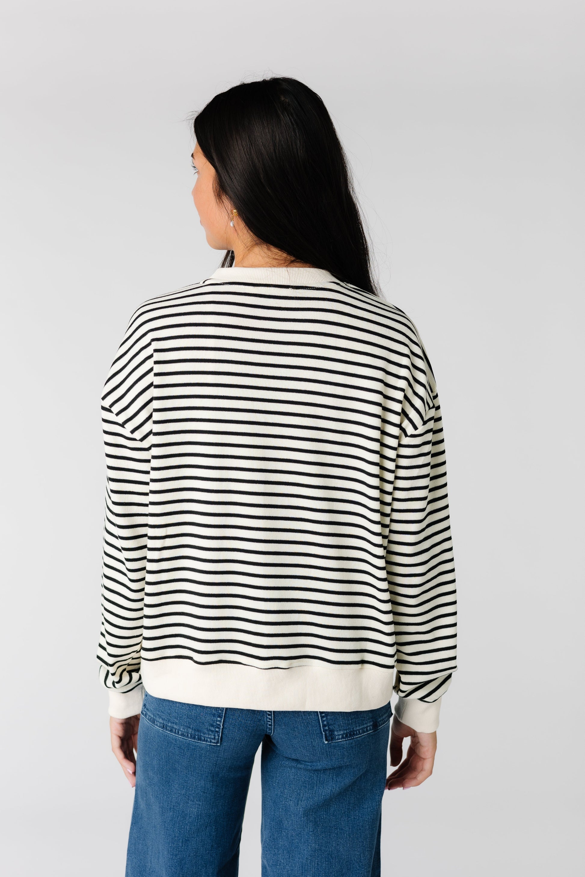 Back view of modest black and & stripe sweater