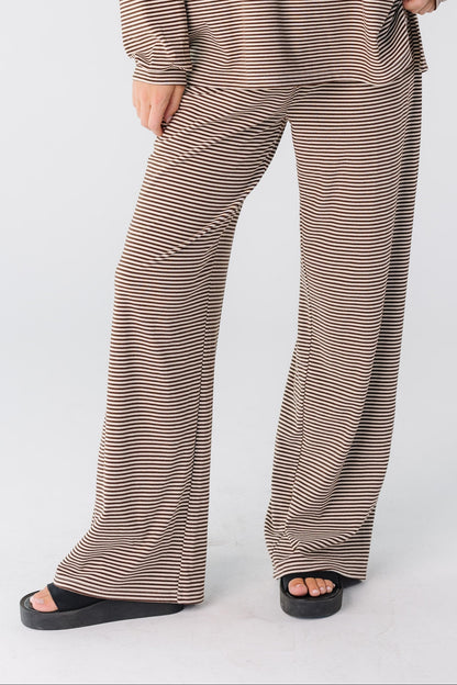 A woman wearing a brown stripe wide leg pant