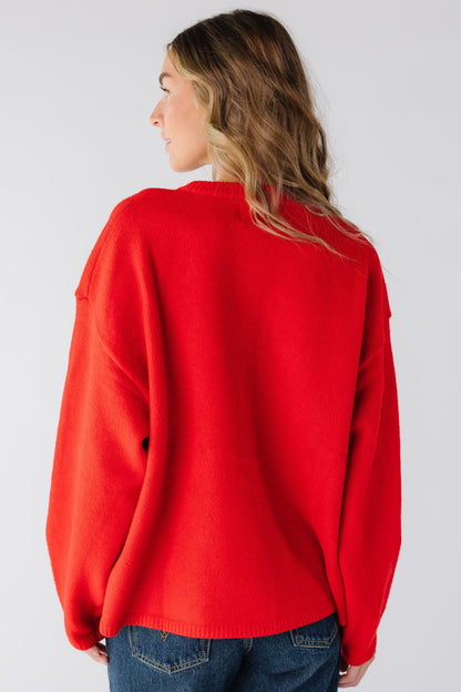 Back view of a woman wearing a red loose fitting cardigan