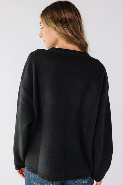 Back view of a woman wearing a black cardigan